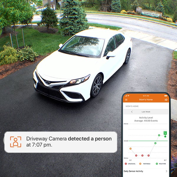 smart home alarm.com app with notification and car in driveway
